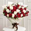 Red and white rose harmony bouquet by Ward and Haneen with fresh, blooming roses arranged beautifully.