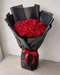 25 pcs Red Rose Bold Bouquet by Ward and Haneen with vibrant red roses arranged in a lush floral display.