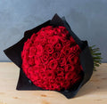 200 pcs red roses in a grand bouquet by Ward and Haneen, showcasing vibrant blooms and lush greenery arranged beautifully.