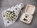 Graduation gift set featuring white roses and a bento cake from Ward and Haneen, beautifully arranged for celebration.