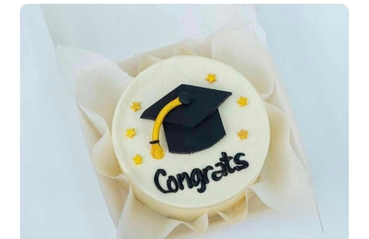 Graduation Bento Cake by Ward and Haneen featuring colorful designs and congratulatory message for graduates.
