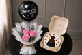 Graduation gift set with pink roses, bento cake, and a "Congrats" balloon from Ward and Haneen.
