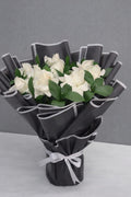White Elegance Rose Bouquet by Ward and Haneen featuring fresh white roses and lush greenery in a beautiful floral arrangement