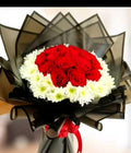 Royal Love red and white floral bouquet by Ward and Haneen featuring mixed roses and greenery in a stylish arrangement.