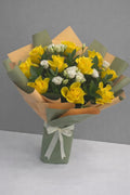 Sunshine Elegance bouquet with 10 yellow roses and 8 white lisianthus in a floral arrangement by Ward and Haneen.