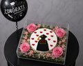 Luxury graduation cake and floral box by Ward and Haneen, featuring a decorated cake with fresh flowers in an elegant box.