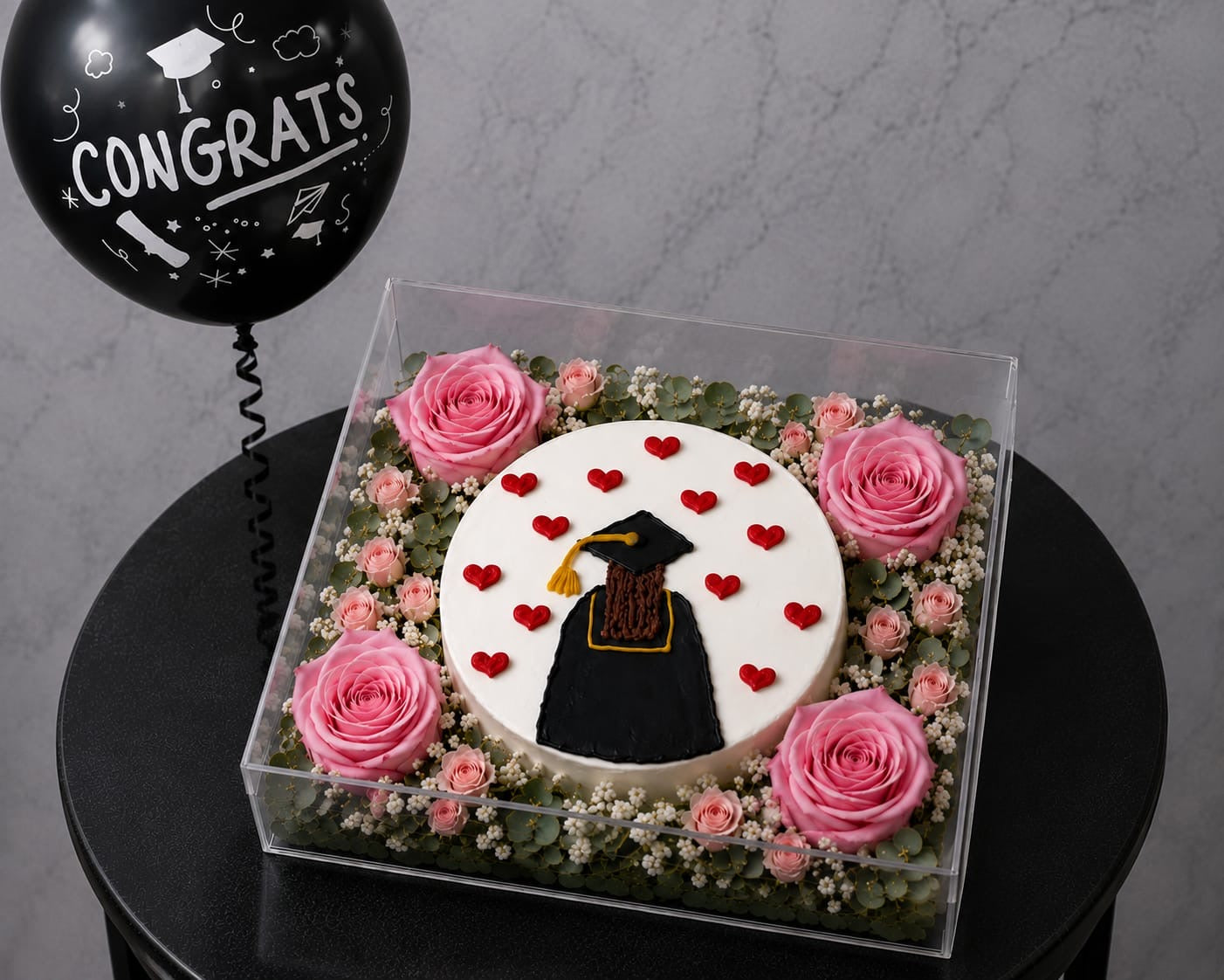 Luxury graduation cake and floral box by Ward and Haneen, featuring a decorated cake with fresh flowers in an elegant box.