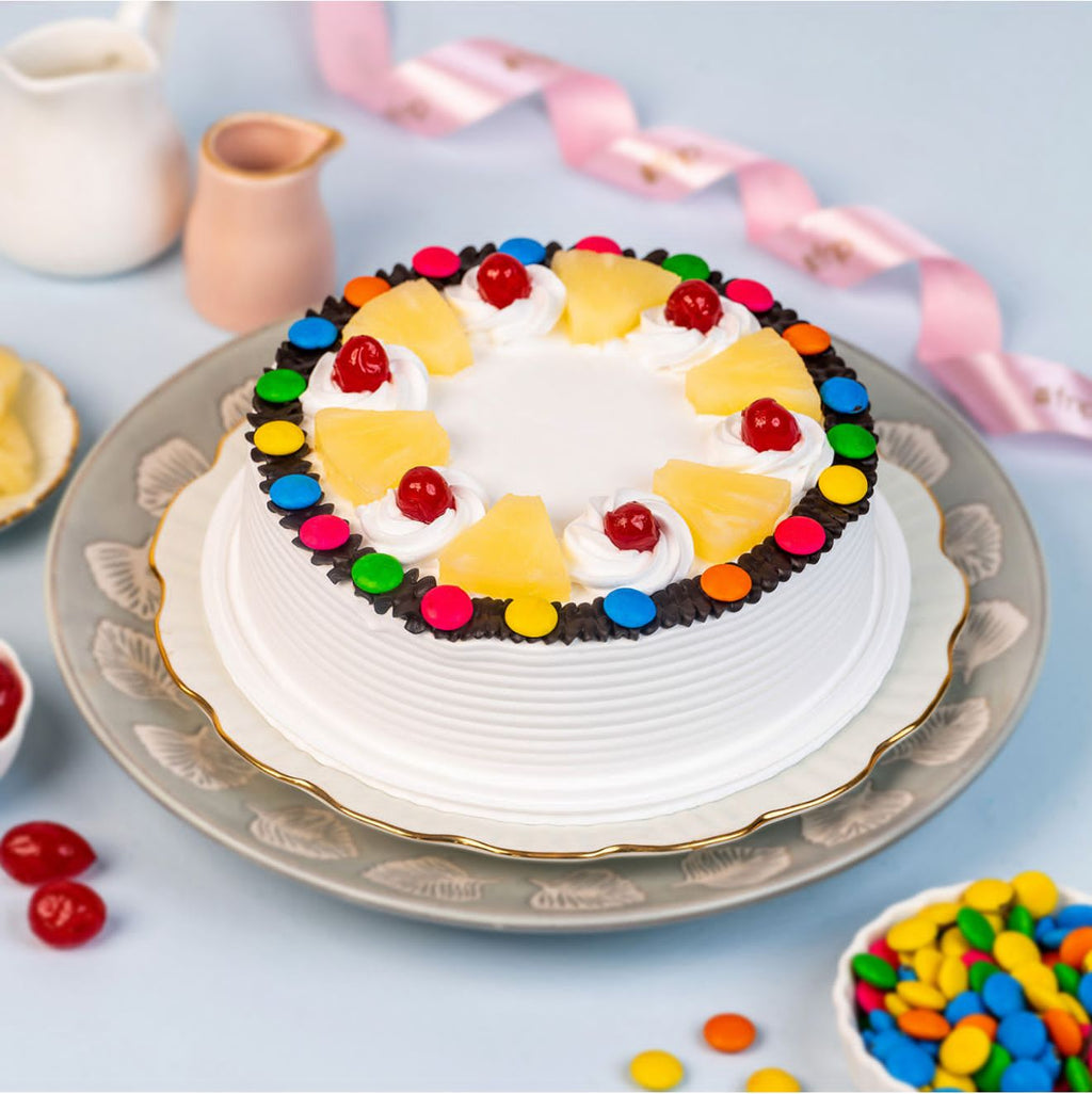 Ward and Haneen Pineapple Gems Cake in 6-inch and 8-inch sizes, decorated with pineapple-themed icing and colorful gems.