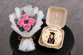 Pink roses and graduation cake set by Ward and Haneen featuring vibrant floral decorations and a celebratory cake.