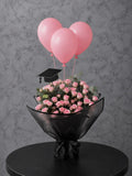 Pink roses graduation bouquet set by Ward and Haneen with vibrant pink roses and greenery, perfect for celebrating graduation.