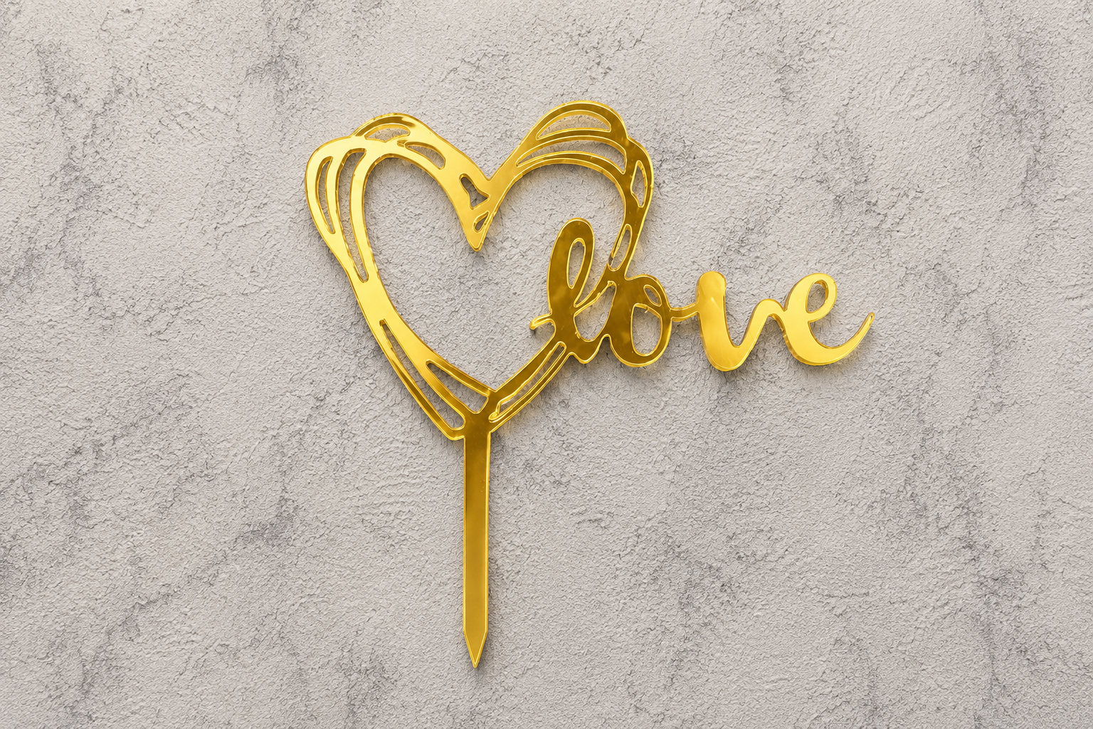 Gold love heart cake topper by Ward and Haneen, featuring a shiny metallic finish and decorative heart design for celebration cakes.