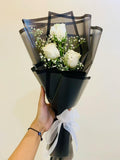 White rose bouquet by Ward and Haneen with fresh white roses arranged in a beautiful floral display.