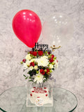 Romantic birthday surprise combo by Ward and Haneen with flowers, balloons, and gift items arranged for celebration.
