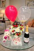 Elegant birthday surprise gift set by Ward and Haneen, featuring colorful wrapped presents and decorative birthday accessories.