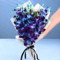 Ward and Haneen Midnight Mirage Orchid bouquet featuring elegant purple orchids and lush greenery in a stylish arrangement.