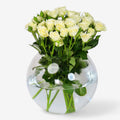 White crystal vase with blooming baby roses, elegant floral arrangement by Ward and Haneen