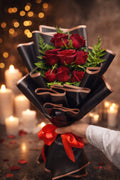 Luxury red rose hand bouquet with black wrapping by Ward and Haneen, featuring vibrant red roses arranged elegantly.