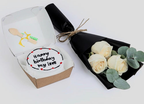 Ward and Haneen birthday bento cake with white roses bouquet, featuring colorful cake slices and elegant floral arrangement.