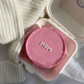 Mini pink "MOM" Bento cake from Ward and Haneen featuring a minimalist design with smooth pink icing and decorative lettering.