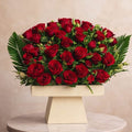 Luxury red rose stand arrangement by Ward and Haneen featuring vibrant roses in an elegant display.