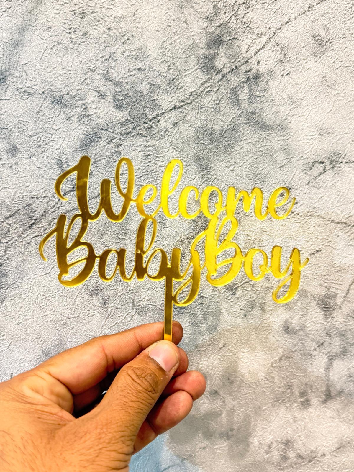 Gold Welcome Baby Boy cake topper by Ward and Haneen featuring a stylish, decorative design for celebration cakes.