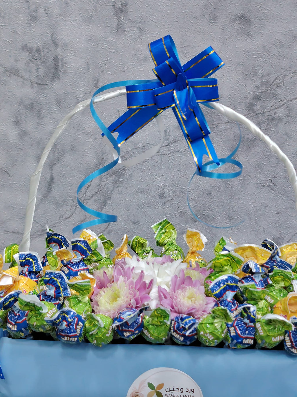 Ward and Haneen deluxe chocolate gift box with blue balloons, featuring an elegant assortment of chocolates in a festive presentation.